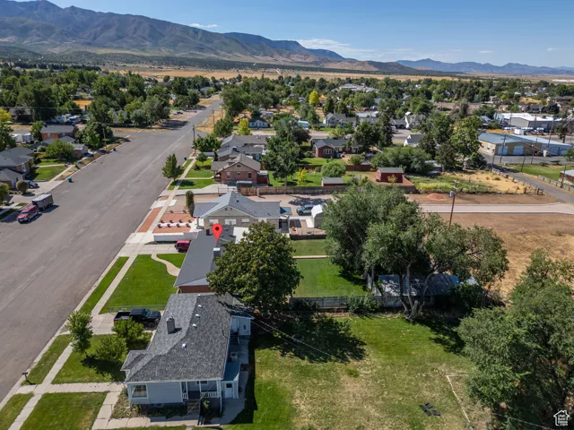Aerial view of residential area featuring a mountainous background