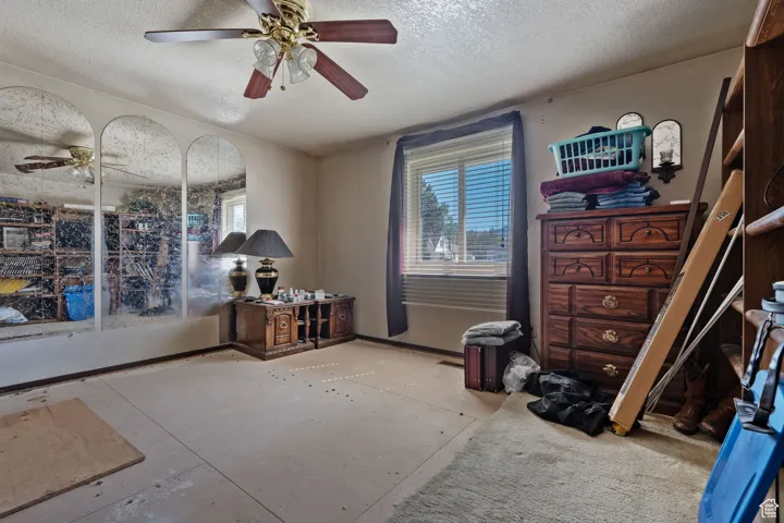 Bedroom featuring a textured ceiling and ceiling fan
