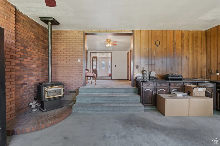 View of exterior entry with area for grilling and a ceiling fan