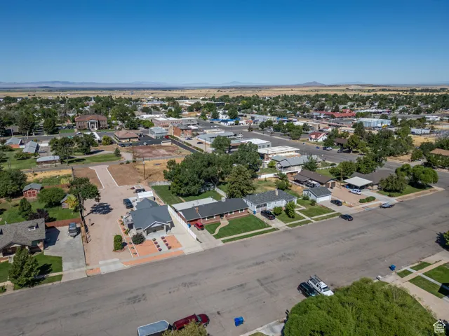 Aerial overview of property's location with nearby suburban area and mountains
