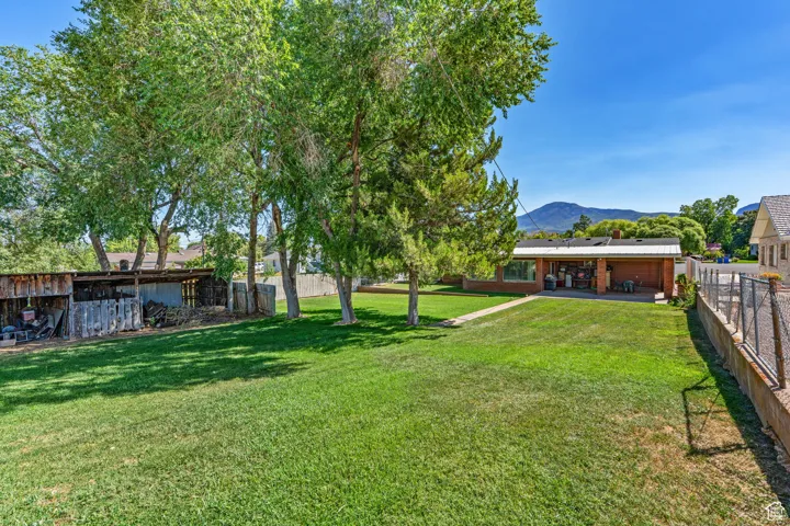 Fenced backyard with a mountain view and a patio