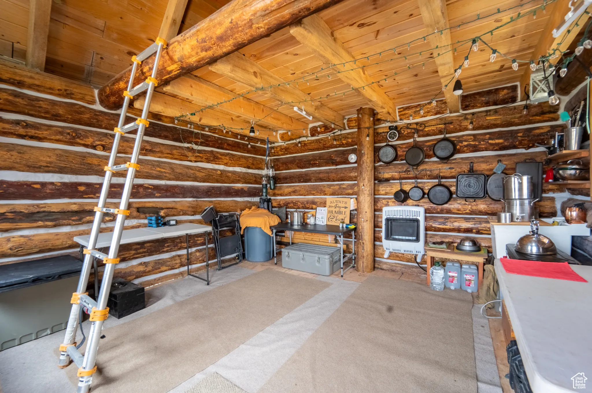 Storage room featuring heating unit and a garage