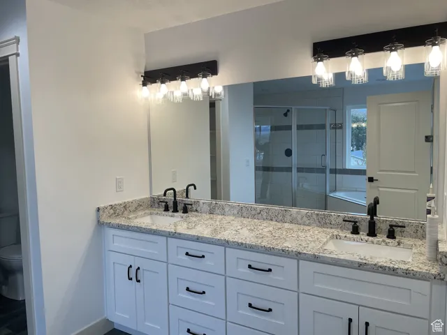 Full bath with a shower stall, a garden tub, and double vanity