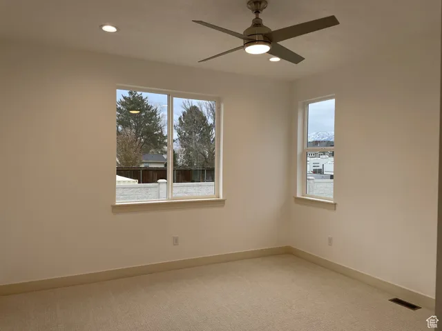 Empty room featuring carpet floors, recessed lighting, and ceiling fan