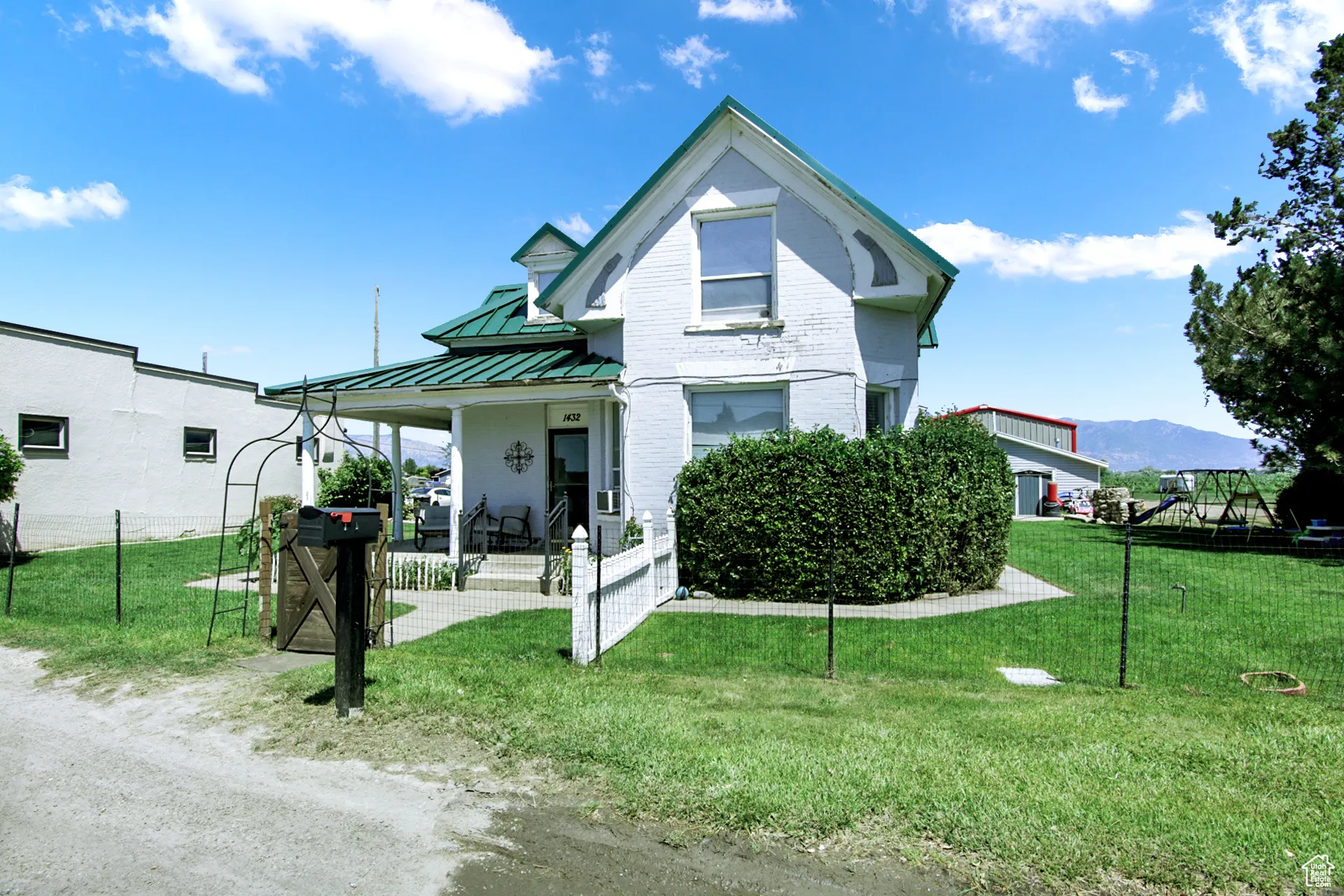 View of front of home with covered porch, a standing seam roof, and a metal roof