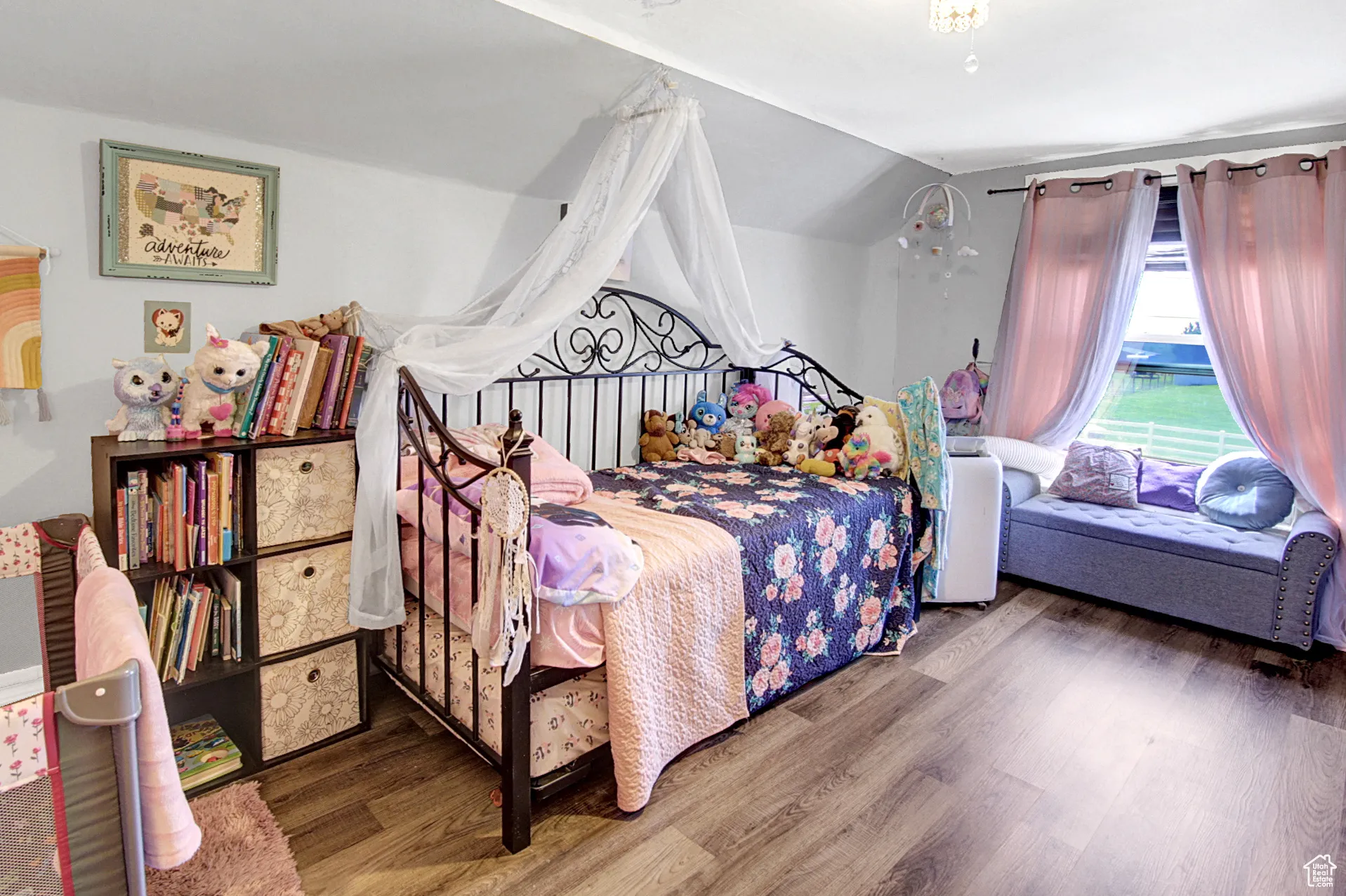 Bedroom featuring wood finished floors and lofted ceiling