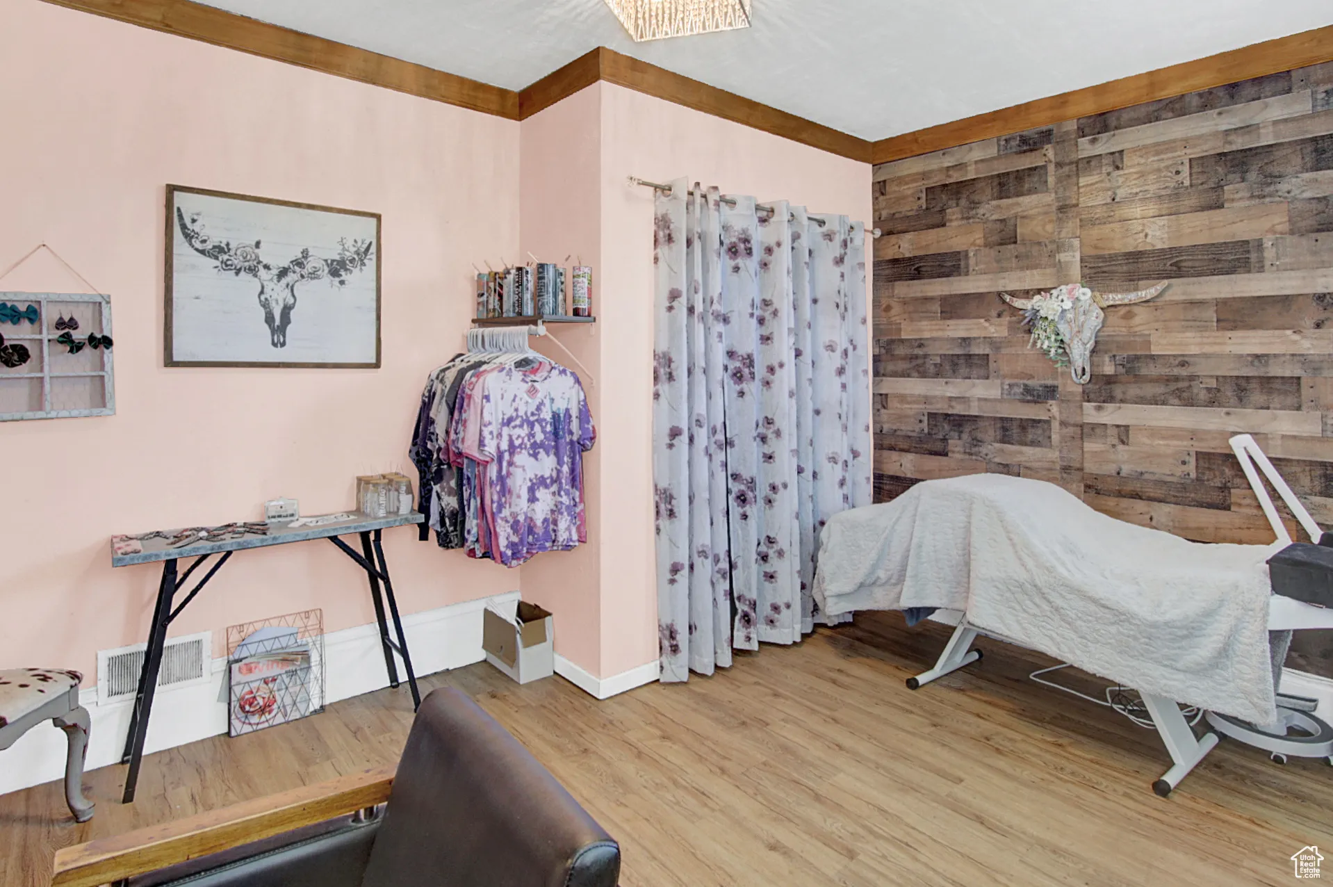 Bedroom featuring wooden walls and wood finished floors
