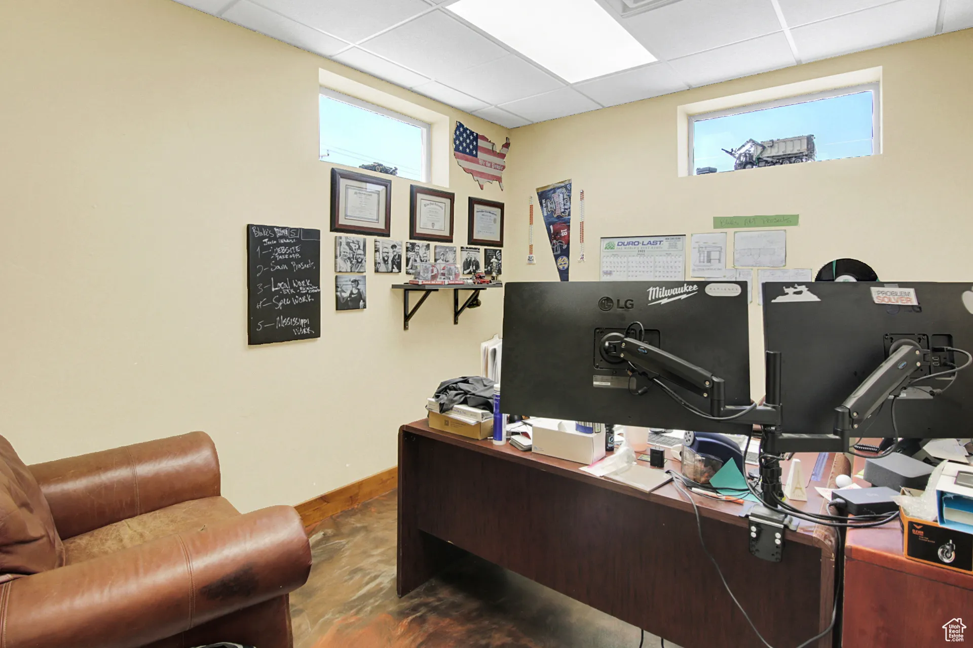 Office with a drop ceiling and baseboards
