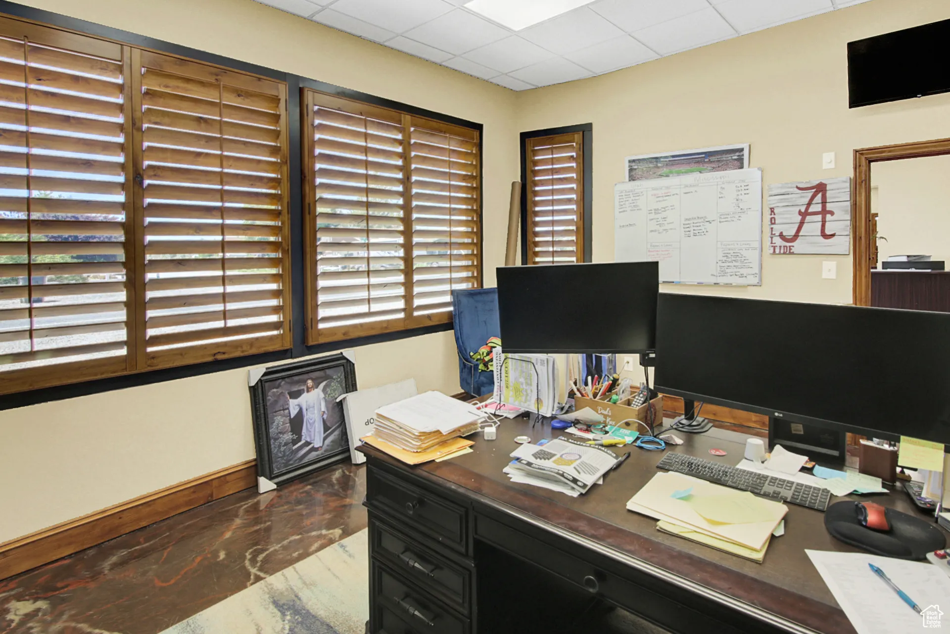Home office featuring baseboards and a paneled ceiling