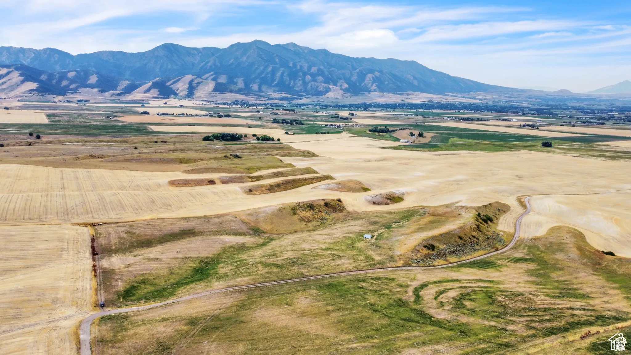 View of mountain backdrop with rural landscape