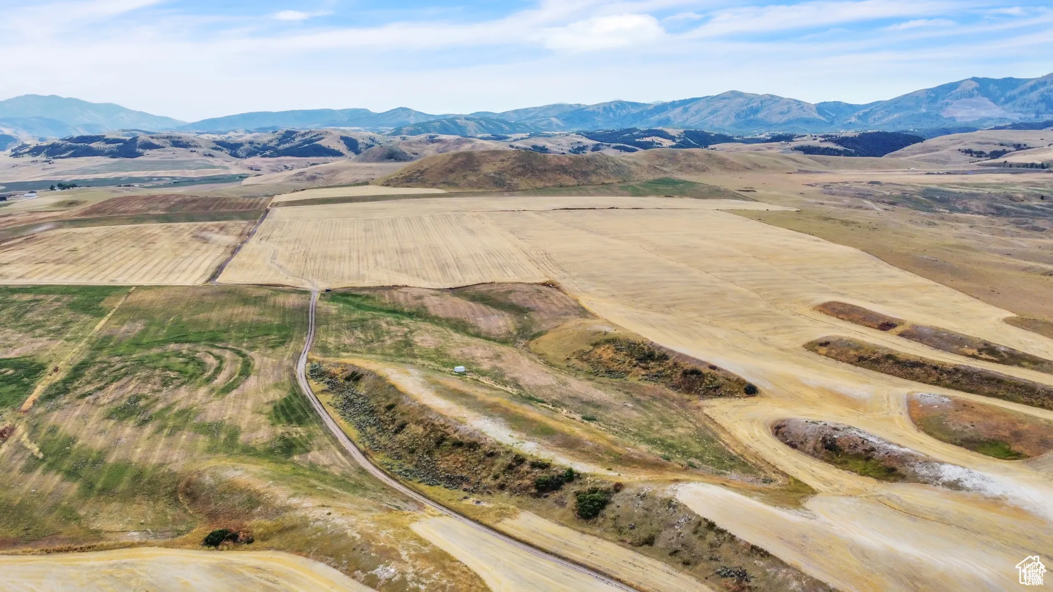 Aerial view of sparsely populated area featuring mountains and extensive farmland