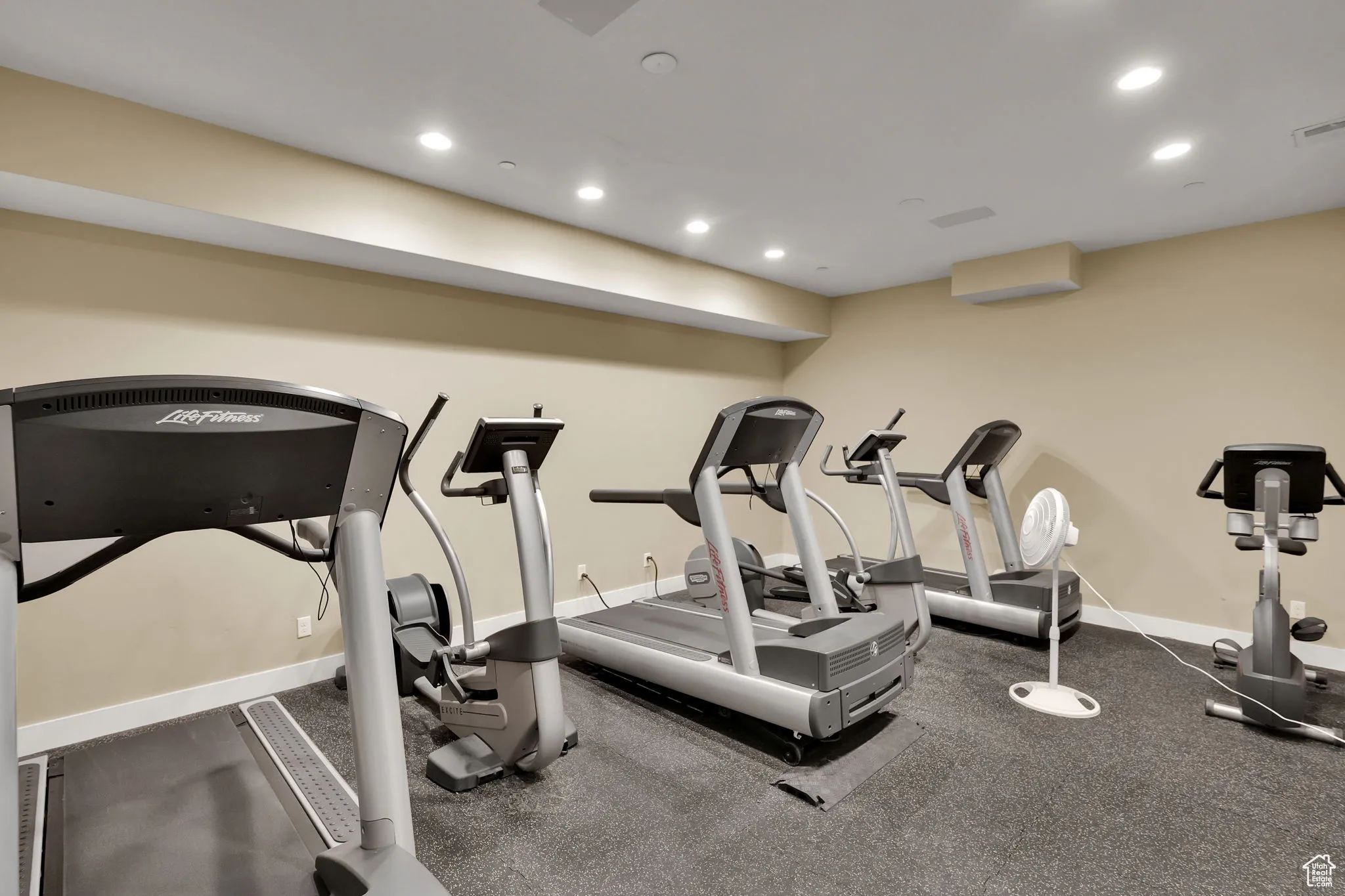 Workout area with recessed lighting and baseboards