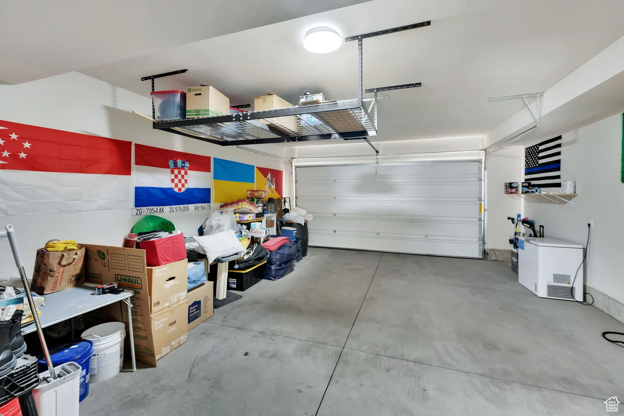 View of garage with ceiling rack for storage (included with strong offer!)