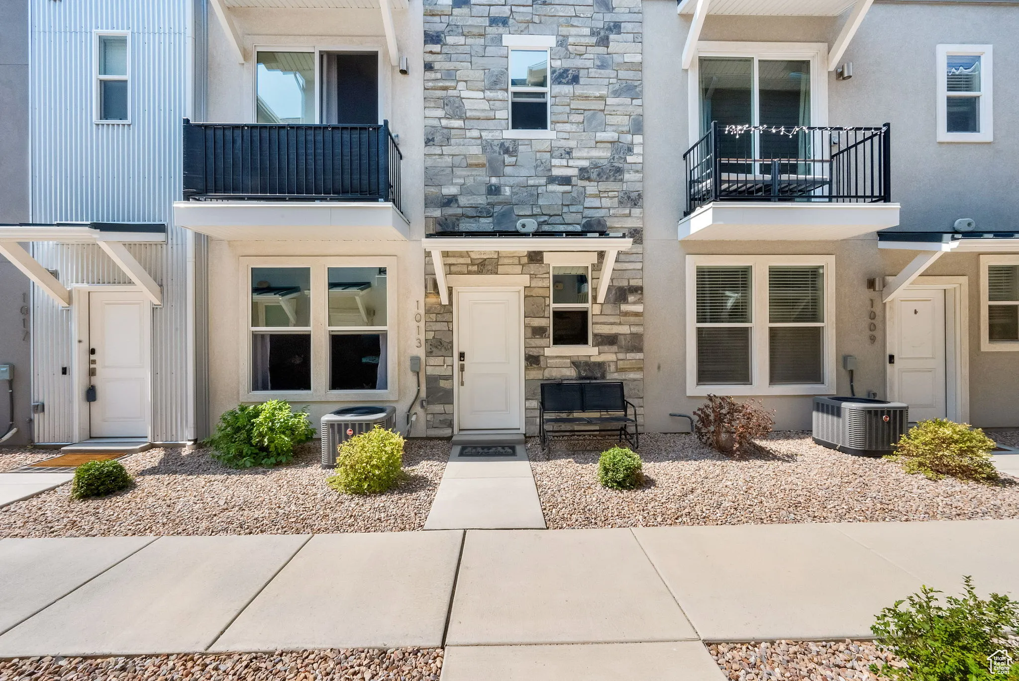 View of exterior entry featuring stone siding and stucco siding