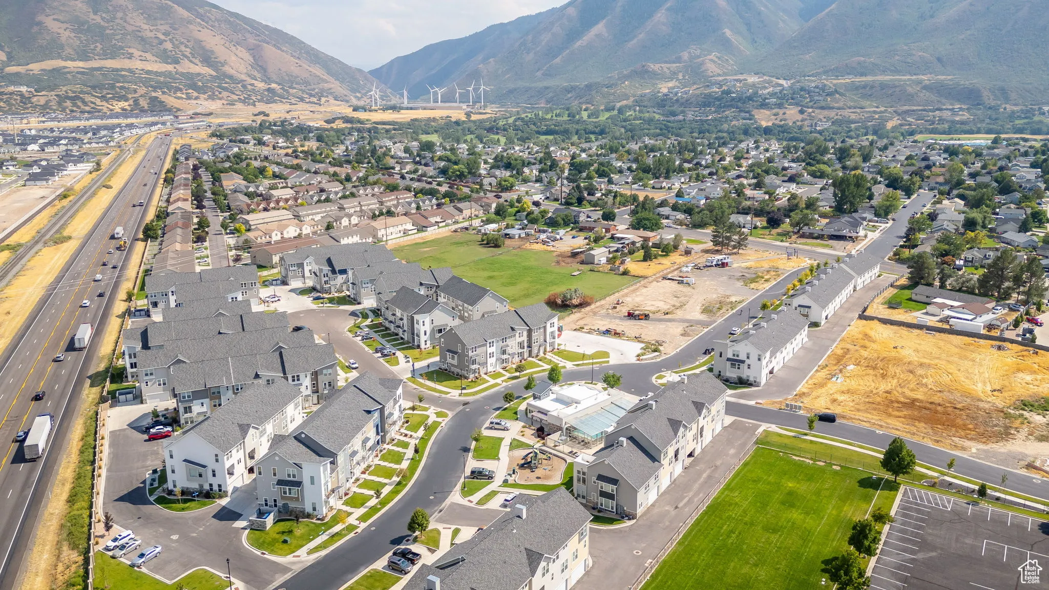 Aerial overview of property's location with nearby suburban area and mountains