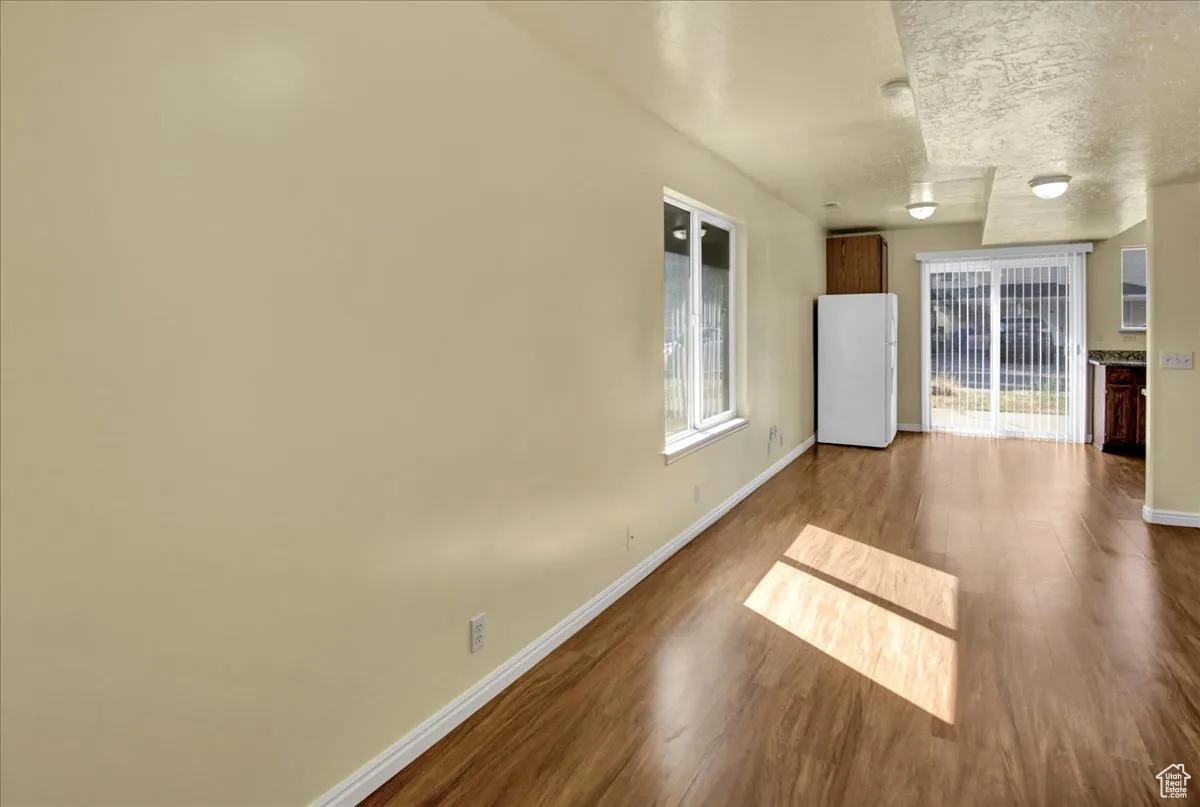 Spare room with dark wood finished floors and a textured ceiling