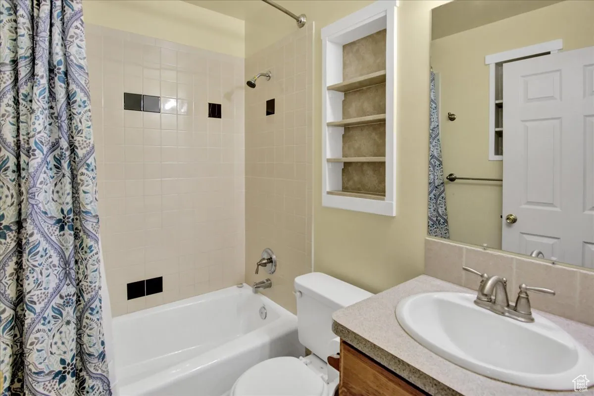 Bathroom featuring shower / bath combo and vanity
