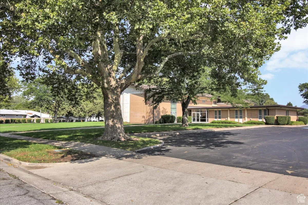 View of front facade with a front lawn and brick siding