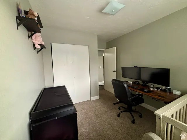 Carpeted office featuring baseboards