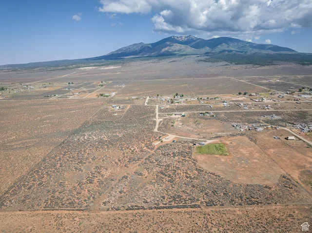 Aerial view of sparsely populated area featuring a mountainous background and a desert landscape