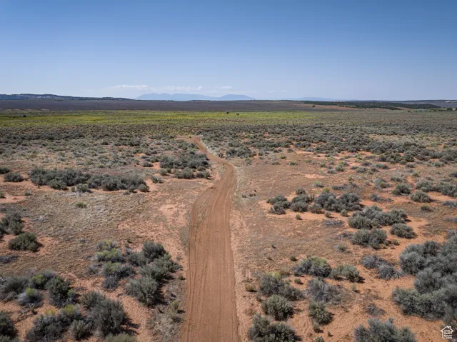 Aerial view of sparsely populated area with a mountainous background and a desert landscape