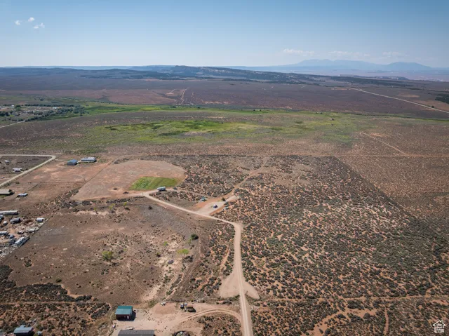 Aerial view of property and surrounding area featuring rural landscape and mountains