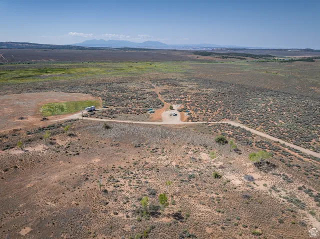 View of rural area featuring a mountain backdrop and a desert landscape