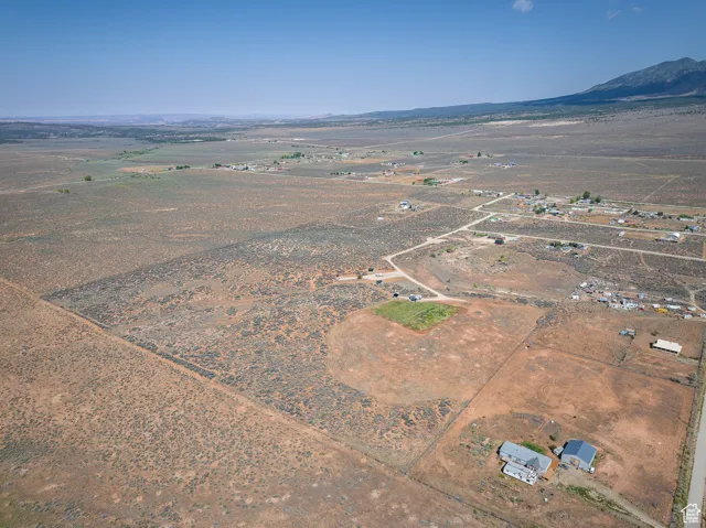 Aerial view of sparsely populated area with a mountainous background and a desert landscape