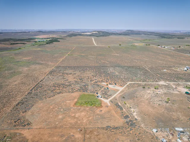 Aerial view of property and surrounding area with rural landscape and a mountainous background