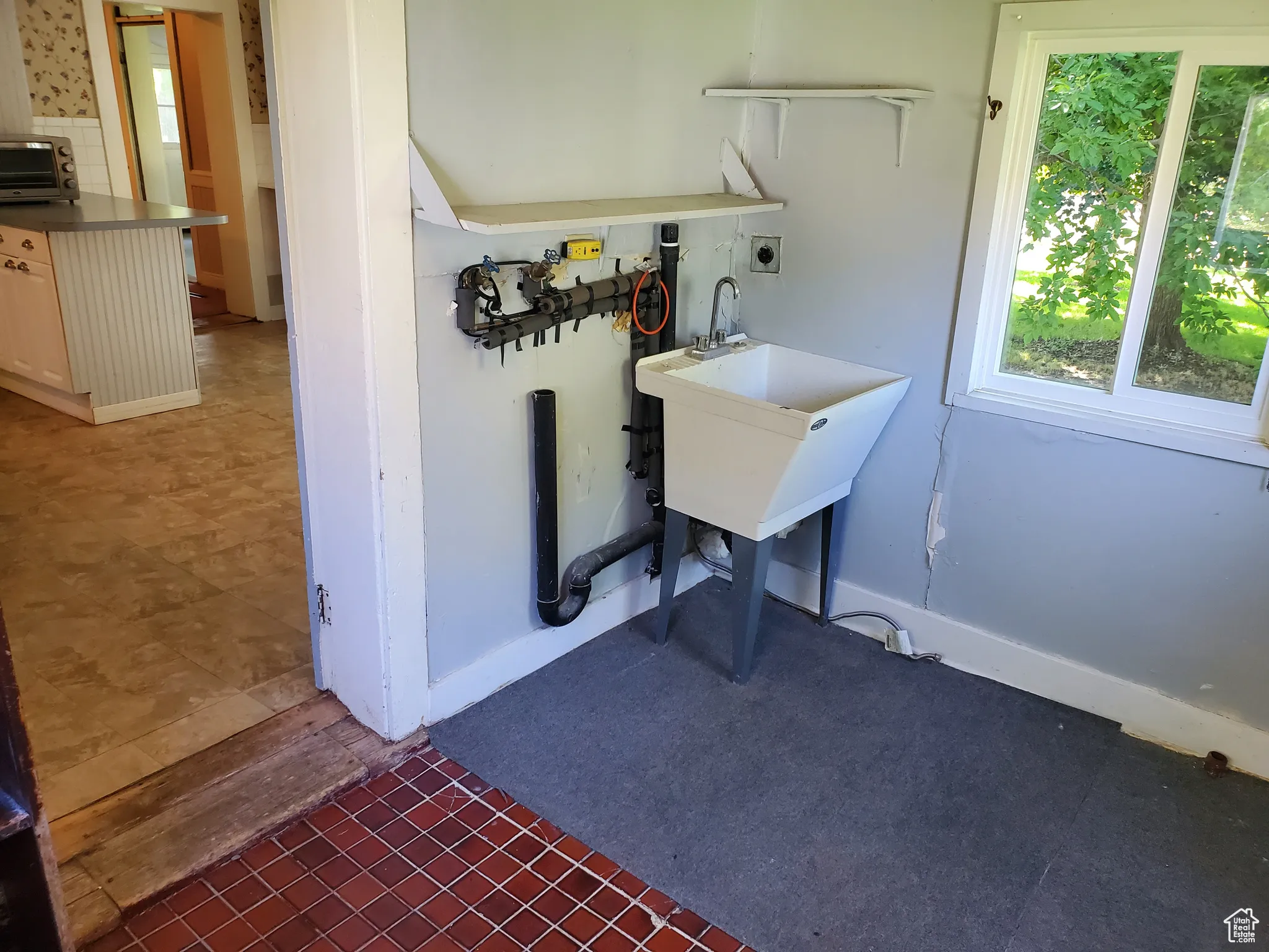 Washroom featuring dark tile patterned floors and a sink