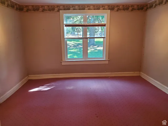 Unfurnished room with baseboards