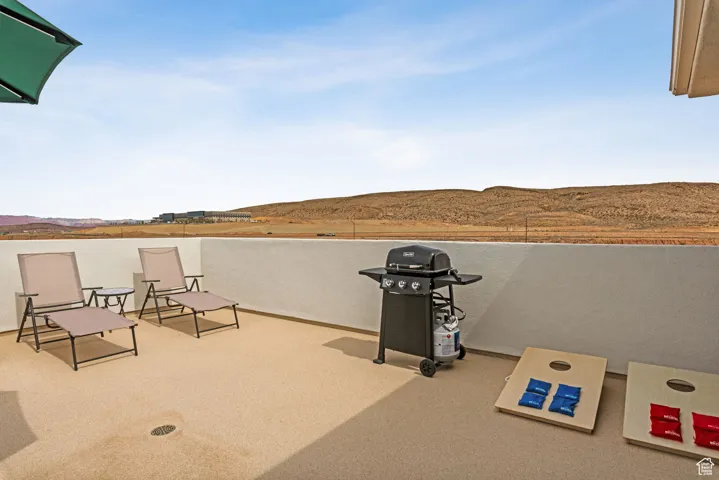 View of patio featuring a grill