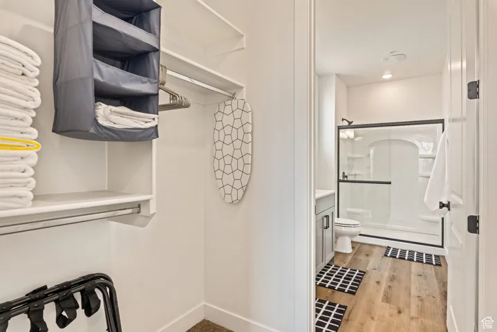 Walk in closet featuring light wood-type flooring