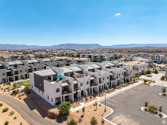 Aerial view of residential area featuring a mountainous background