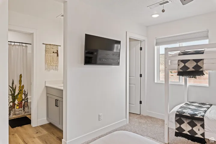 Bedroom featuring ensuite bathroom, a textured ceiling, and recessed lighting
