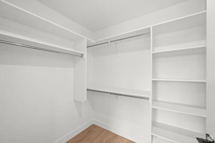 Walk in closet featuring light wood finished floors