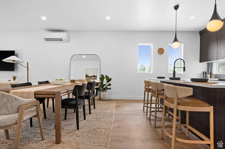Dining area with plenty of natural light, recessed lighting, and light wood-style flooring