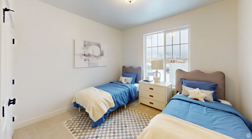 Carpeted bedroom featuring baseboards