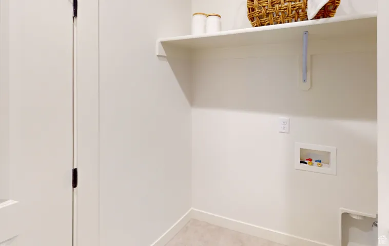 Laundry area with washer hookup and baseboards
