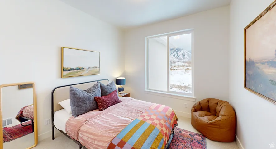 Carpeted bedroom featuring baseboards