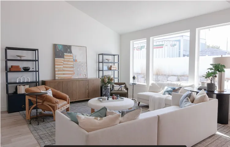 Living room featuring vaulted ceiling and light wood-style flooring