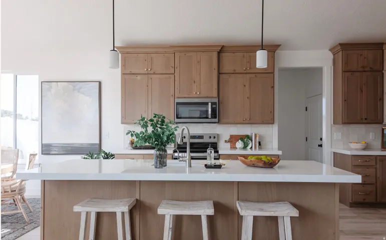Kitchen with stainless steel appliances, decorative backsplash, a breakfast bar, and decorative light fixtures