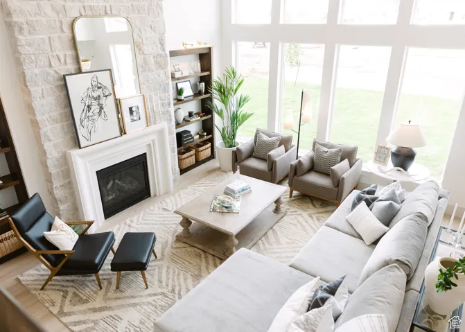 Living area with a glass covered fireplace and wood finished floors