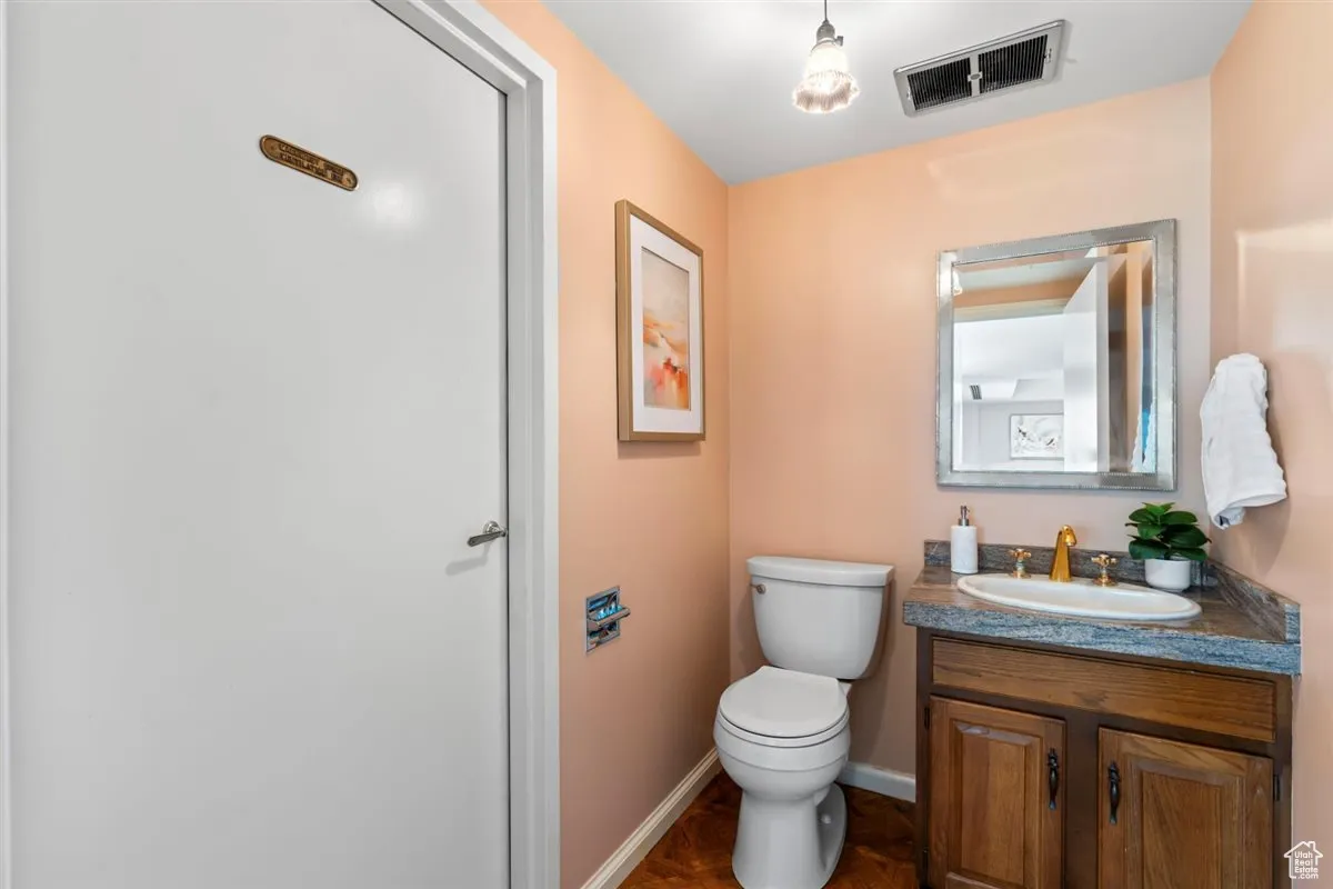 Half bath featuring vanity and toilet