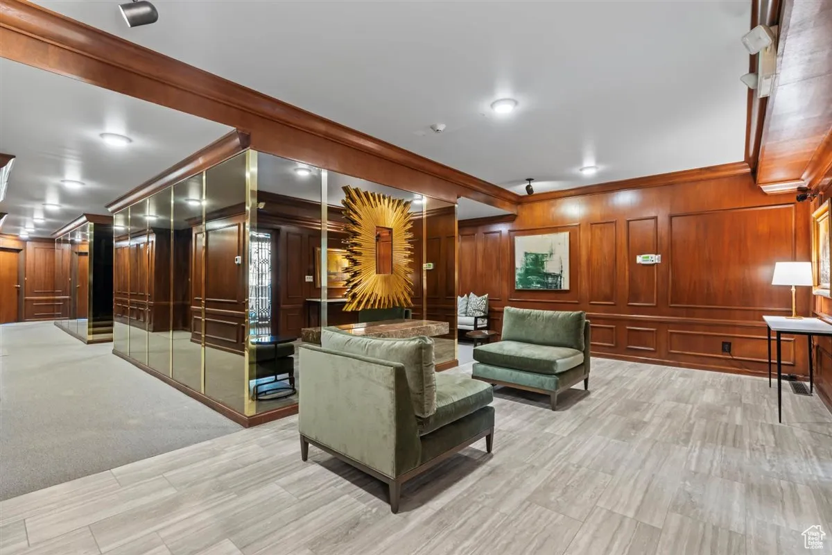 Community lobby with ornamental molding and wood walls