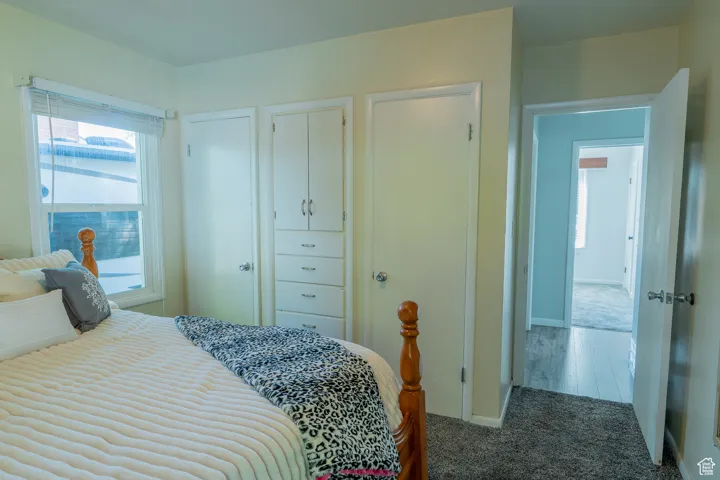 Bedroom featuring carpet floors and baseboards