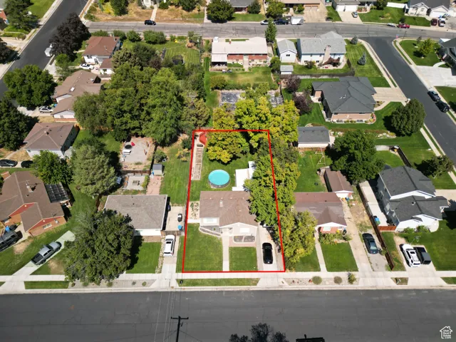 Aerial perspective of suburban area featuring property parcel outlined