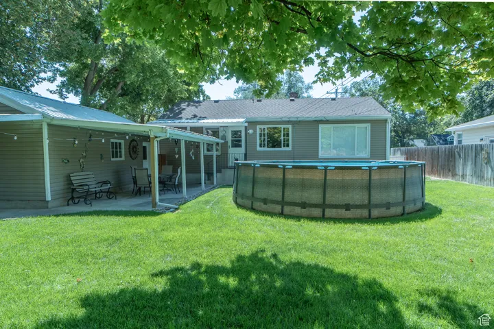 Back of property with a patio area and a lawn