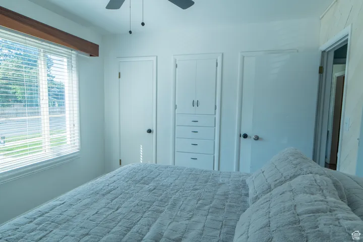 Bedroom featuring multiple closets and a ceiling fan