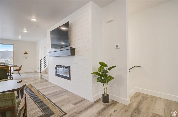 Kitchen featuring light wood-style floors and a large fireplace
